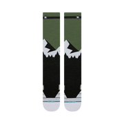 Bas de neige Stance Divide Ultra Light Wool Black, motif de montagnes vert et blanc — paire à plat, côté logo.