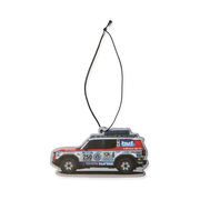 Désodorisant HUF x Toyota Land Cruiser multicolore en forme de véhicule de rallye — face illustrée avec cordon.
