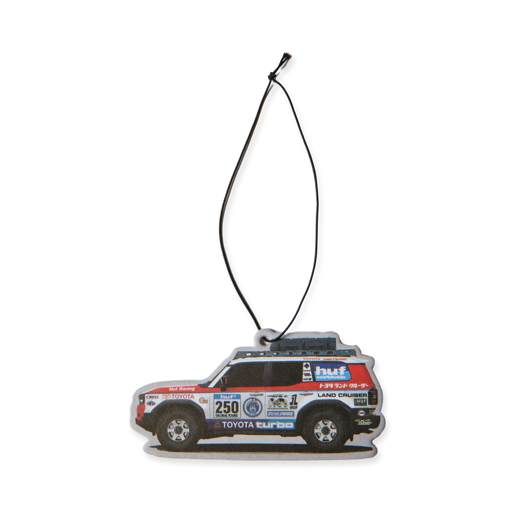 Désodorisant HUF x Toyota Land Cruiser multicolore en forme de véhicule de rallye — face illustrée avec cordon.