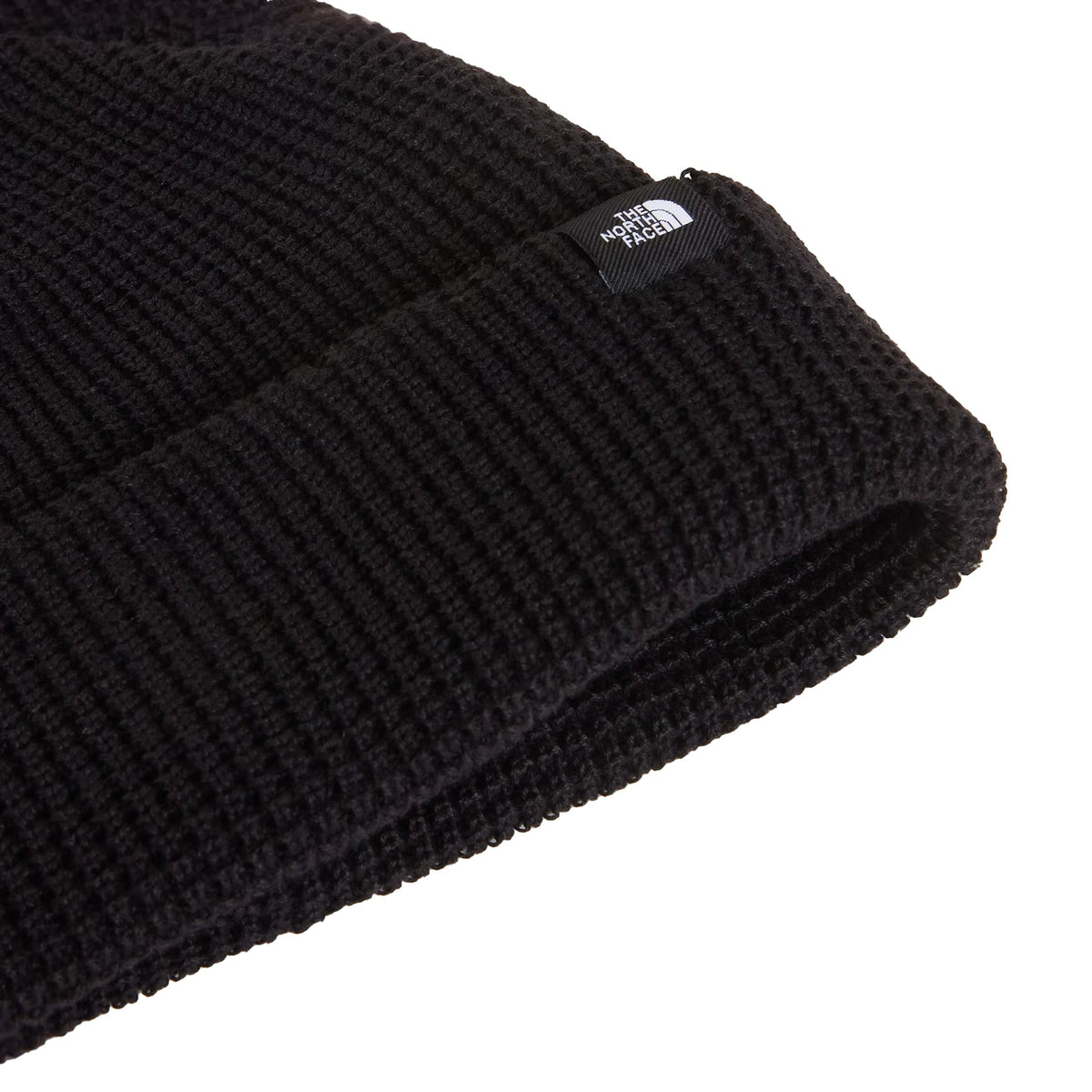 Tuque The North Face Fisherman TNF Black, noire — détail de la maille et de l'étiquette sur le revers.